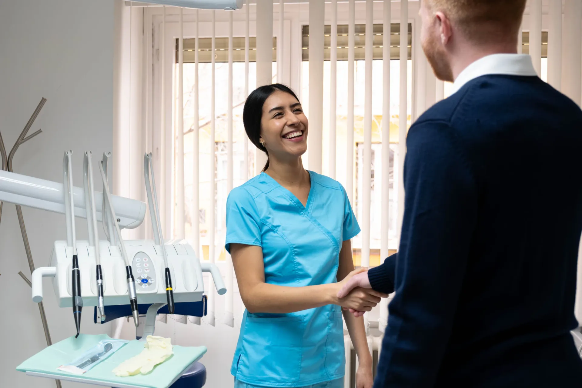 Dentist shaking hands with a reassured patient